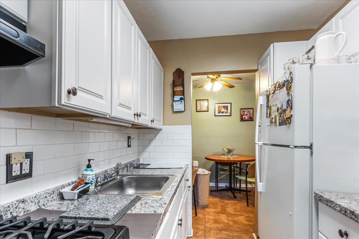 196-66 67th Avenue, Unit 1 Queens, NY 11365 - Photo 11 of 19 a kitchen with stainless steel appliances granite countertop a refrigerator sink and stove