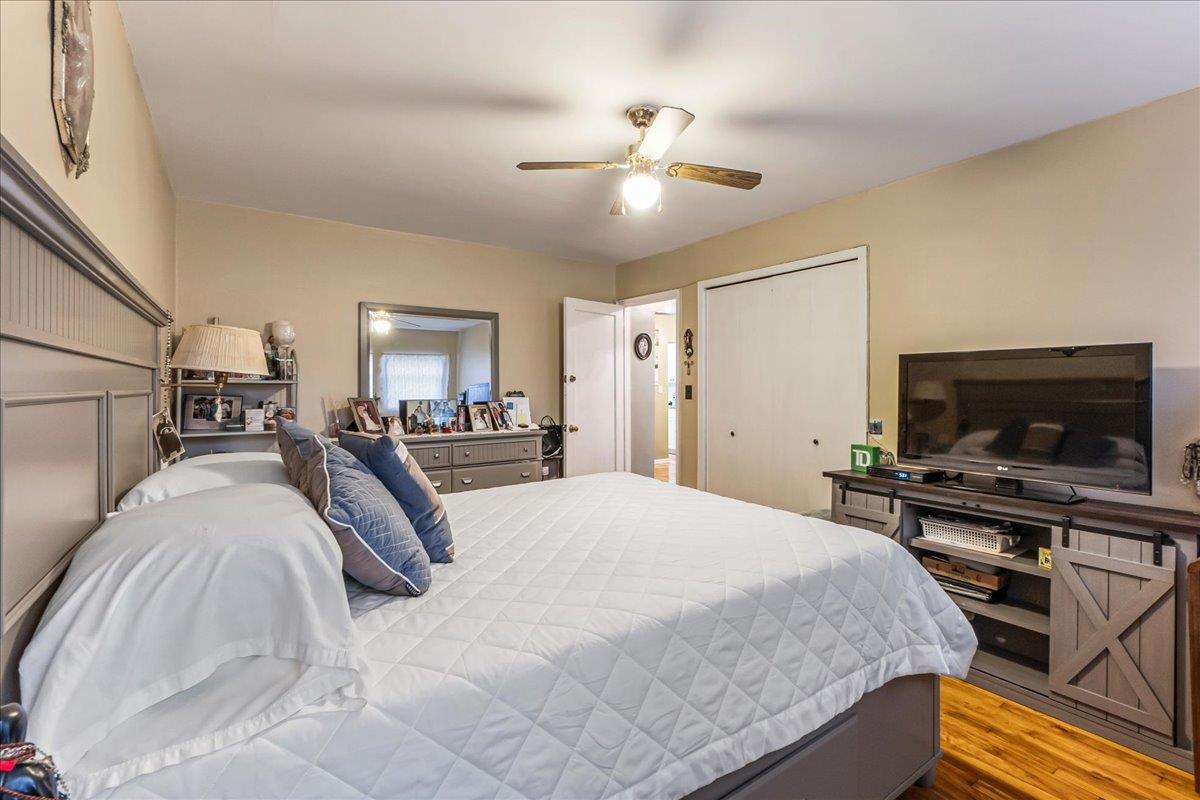 196-66 67th Avenue, Unit 1 Queens, NY 11365 - Photo 14 of 19 a spacious bedroom with a bed and a flat screen tv