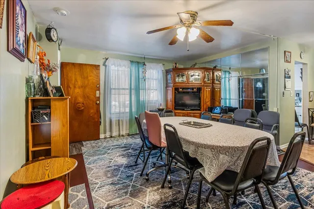 a view of a dining room with furniture and chandelier