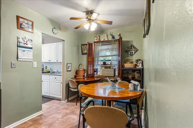 a dining room with a table chairs and a kitchen view