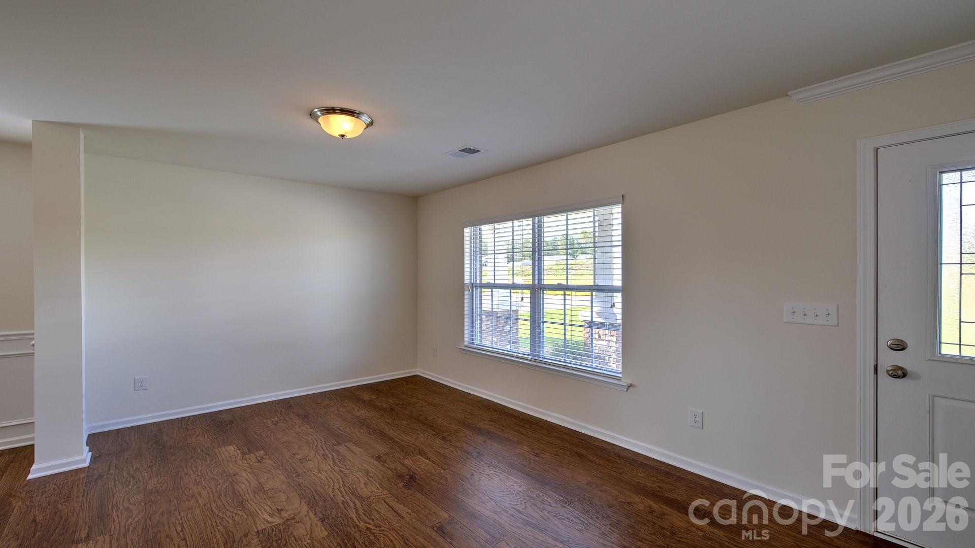 58 Salers Road Fletcher, NC 28732 - Photo 5 of 27 a view of an empty room with wooden floor and a window