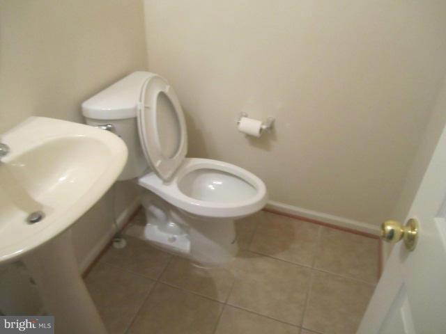 9613 Bird River Road Baltimore, MD 21220 - Photo 12 of 20 a bathroom with a toilet sink and mirror