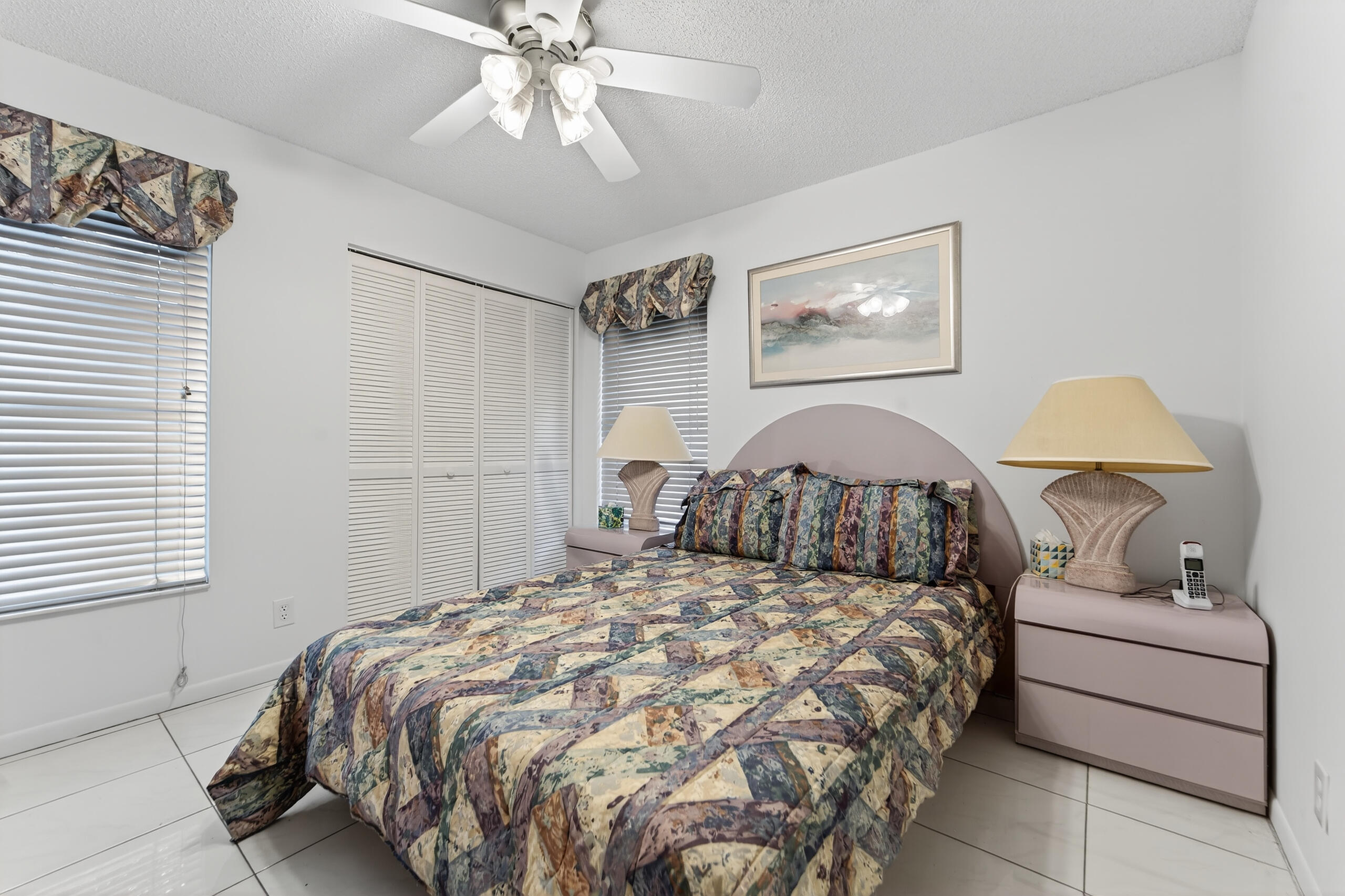 6065 Sunny Manor Court Delray Beach, FL 33484 - Photo 12 of 58 a bedroom with a bed and a lamp