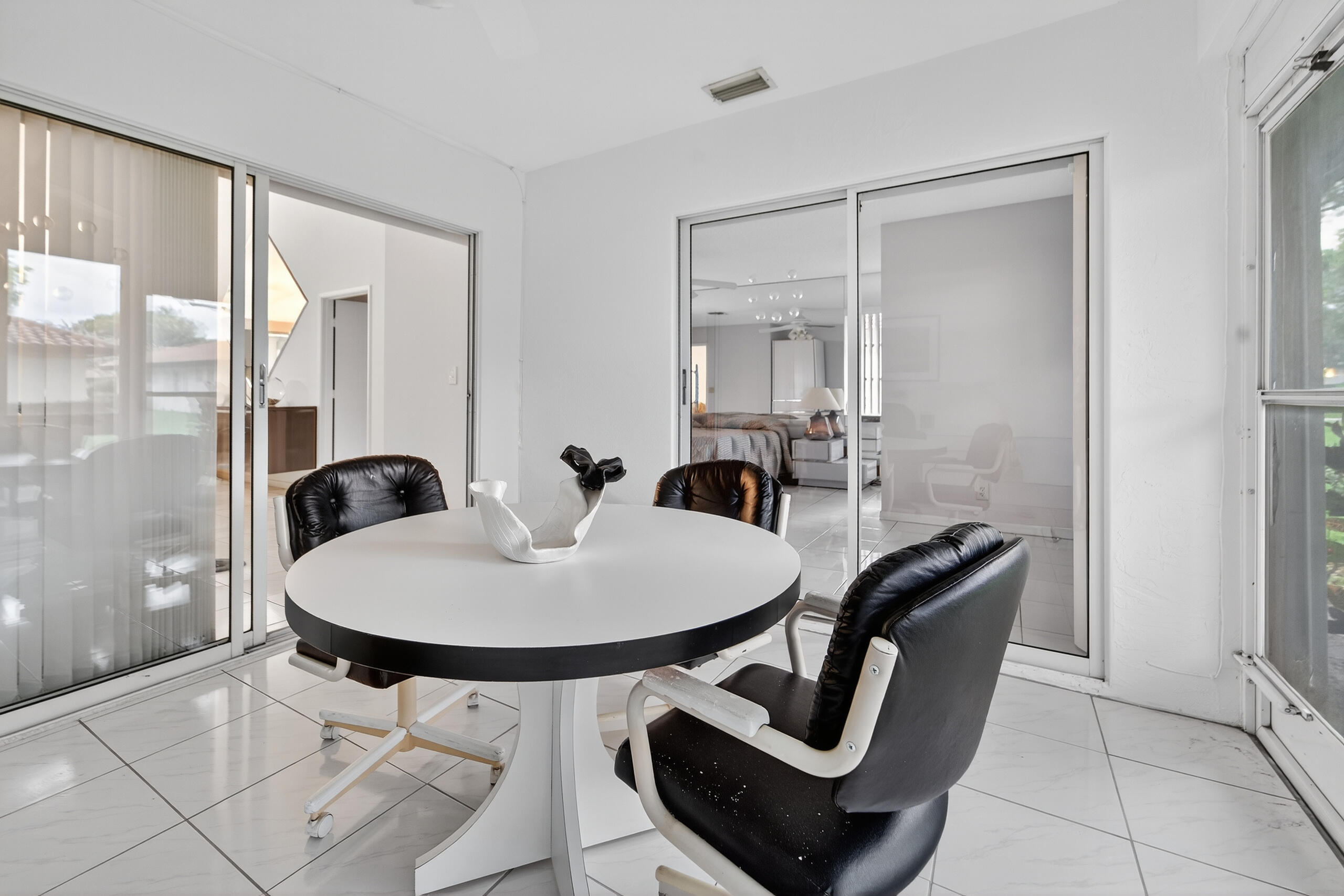6065 Sunny Manor Court Delray Beach, FL 33484 - Photo 21 of 58 a dining room with furniture and wooden floor