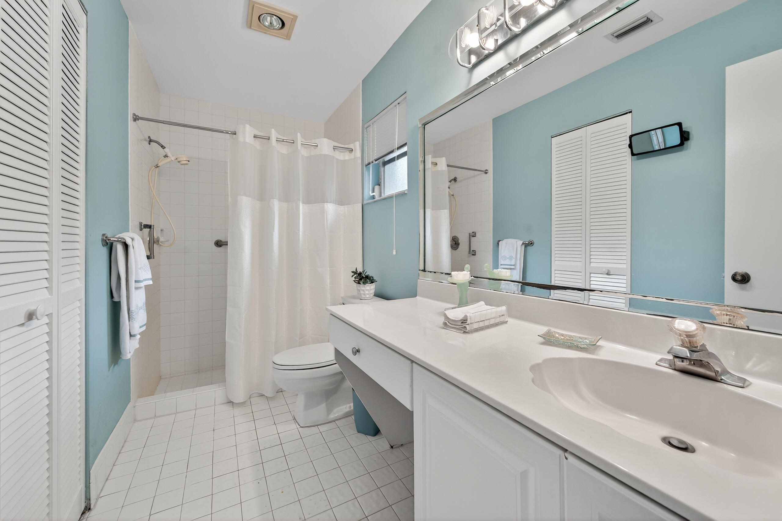6065 Sunny Manor Court Delray Beach, FL 33484 - Photo 23 of 58 a bathroom with a double vanity sink toilet and shower