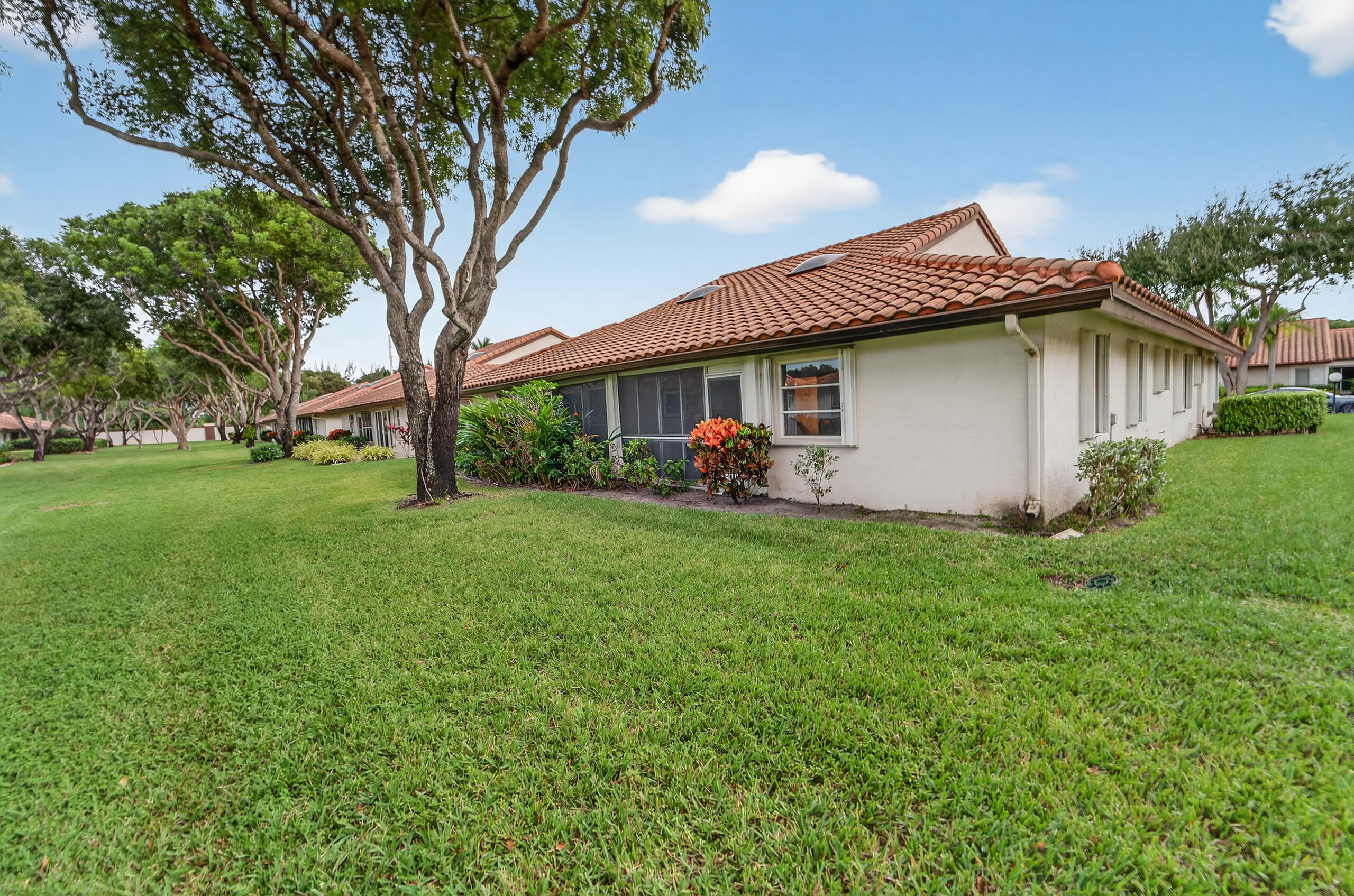 6065 Sunny Manor Court Delray Beach, FL 33484 - Photo 30 of 58 a front view of house with yard and green space