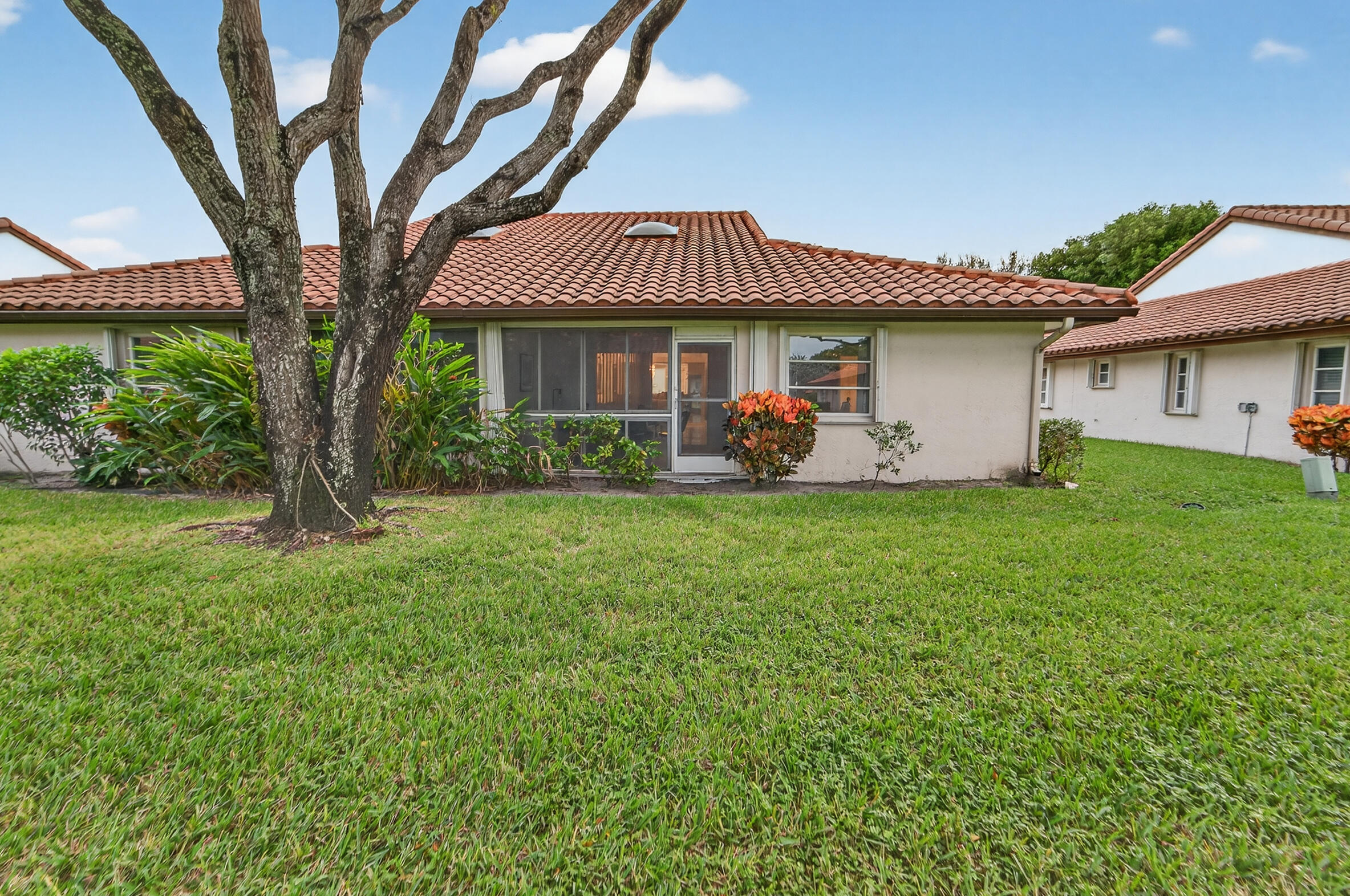 6065 Sunny Manor Court Delray Beach, FL 33484 - Photo 31 of 58 a front view of a house with garden