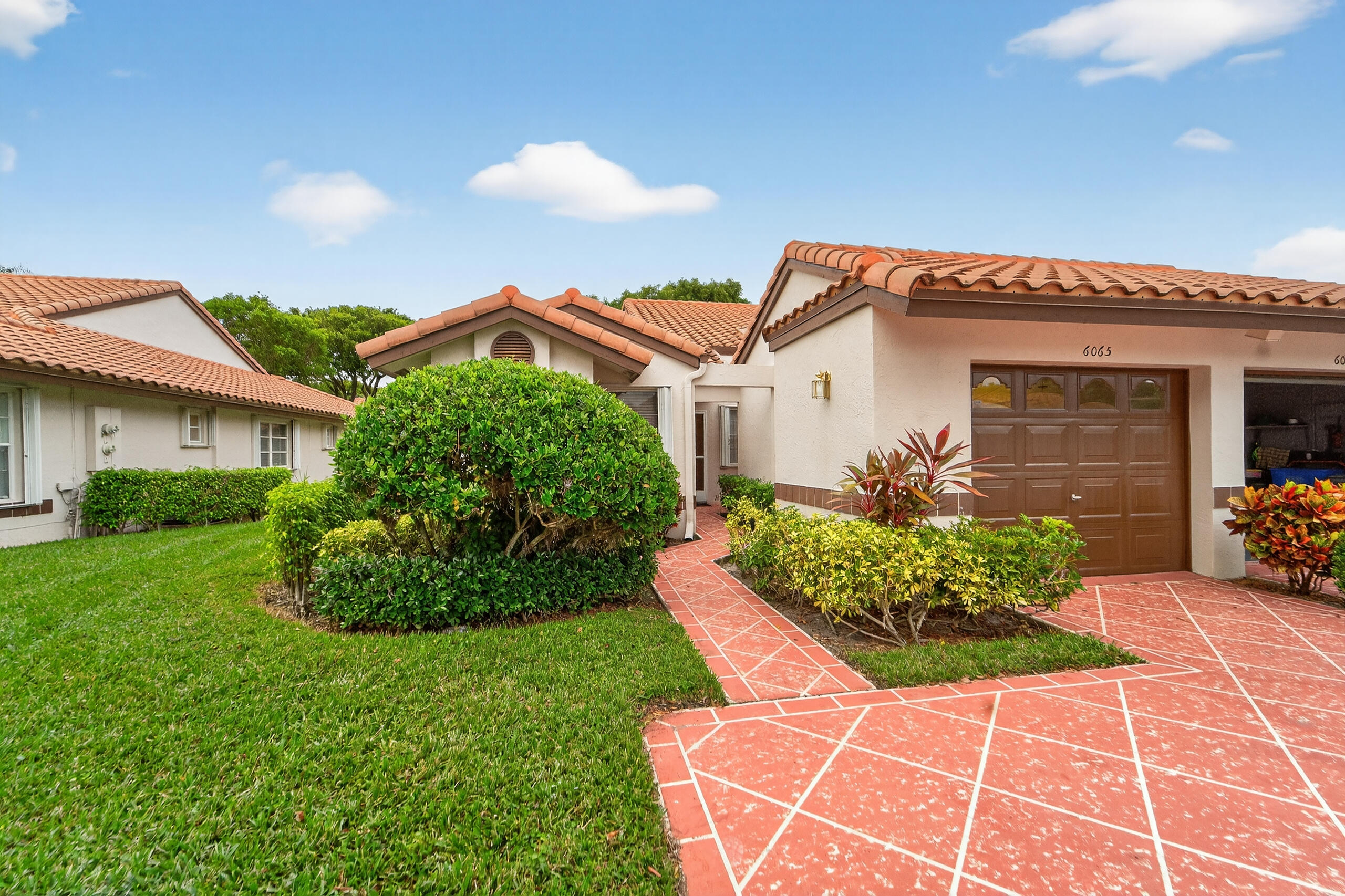 6065 Sunny Manor Court Delray Beach, FL 33484 - Photo 33 of 58 a front view of a house with garden