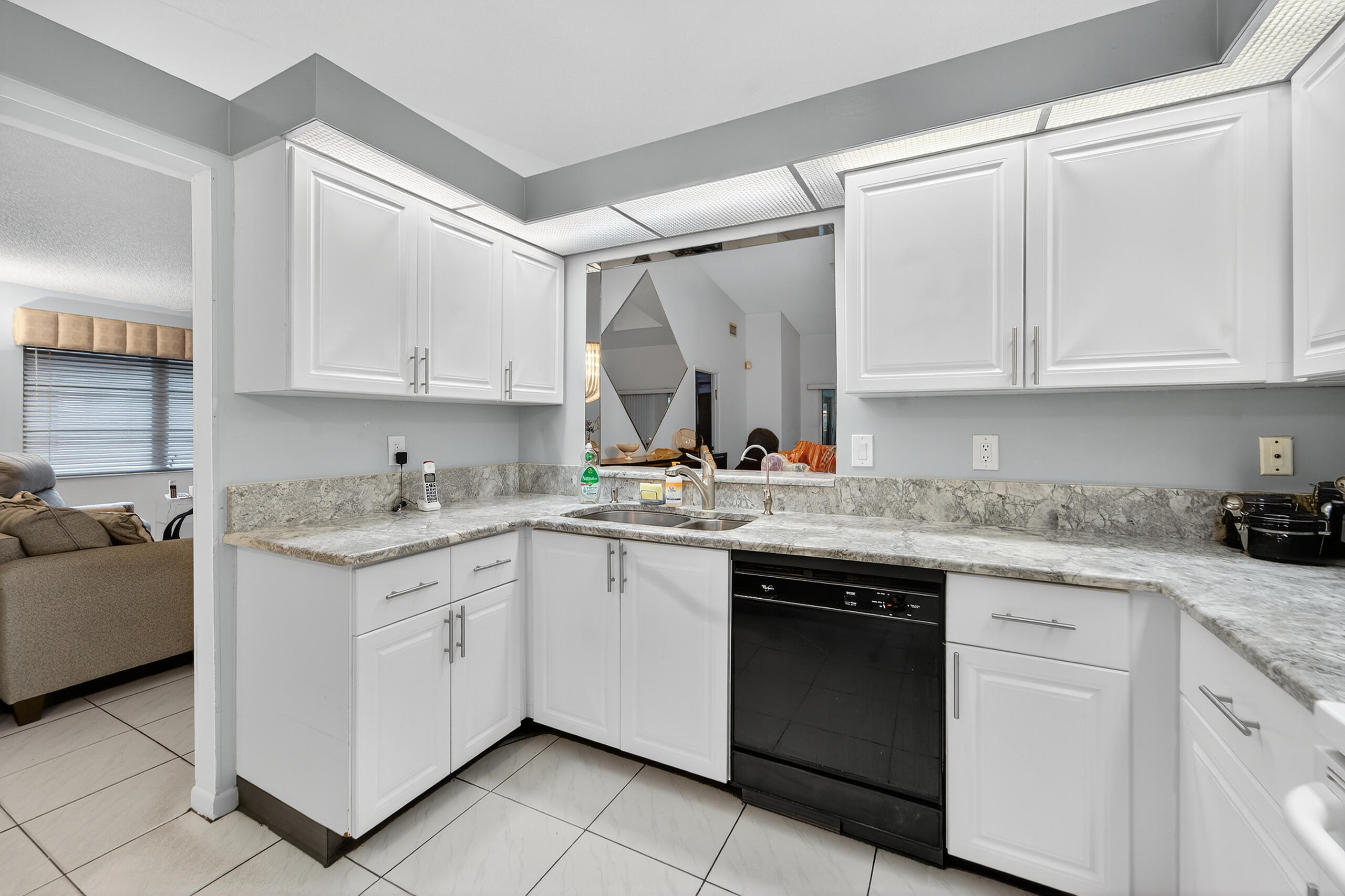 6065 Sunny Manor Court Delray Beach, FL 33484 - Photo 4 of 58 a kitchen with granite countertop a sink stove and cabinets