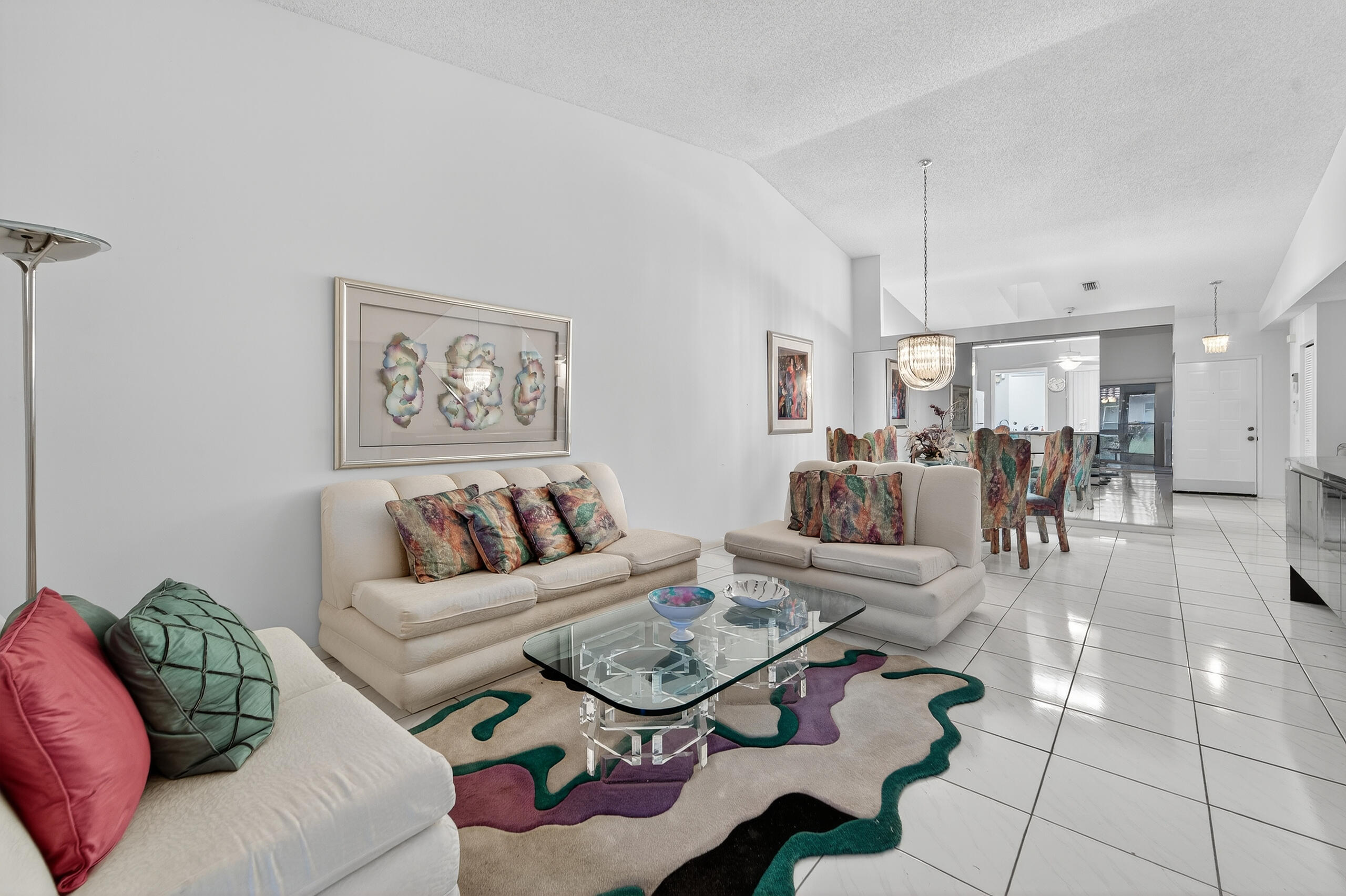 6065 Sunny Manor Court Delray Beach, FL 33484 - Photo 8 of 58 a living room with furniture a dining table and paintings on the wall