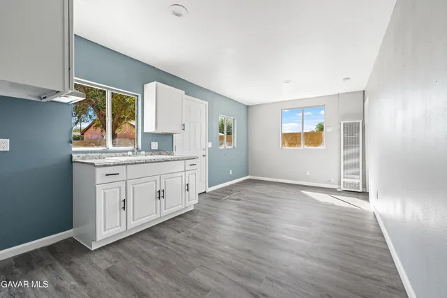 a view of a kitchen with wooden floor