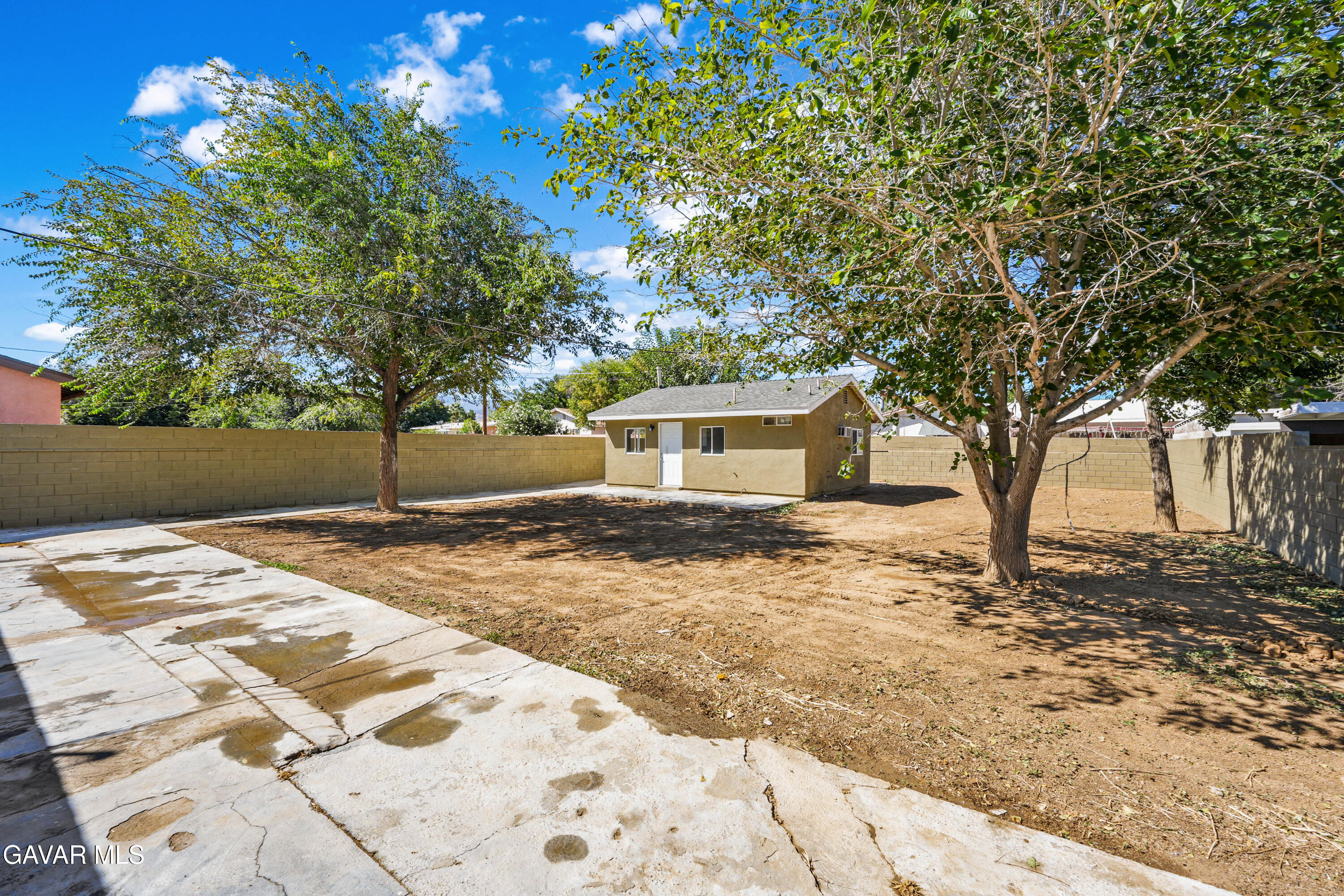 38559 4th Street East Palmdale, CA 93550 - Photo 3 of 5 a front view of a house with a yard