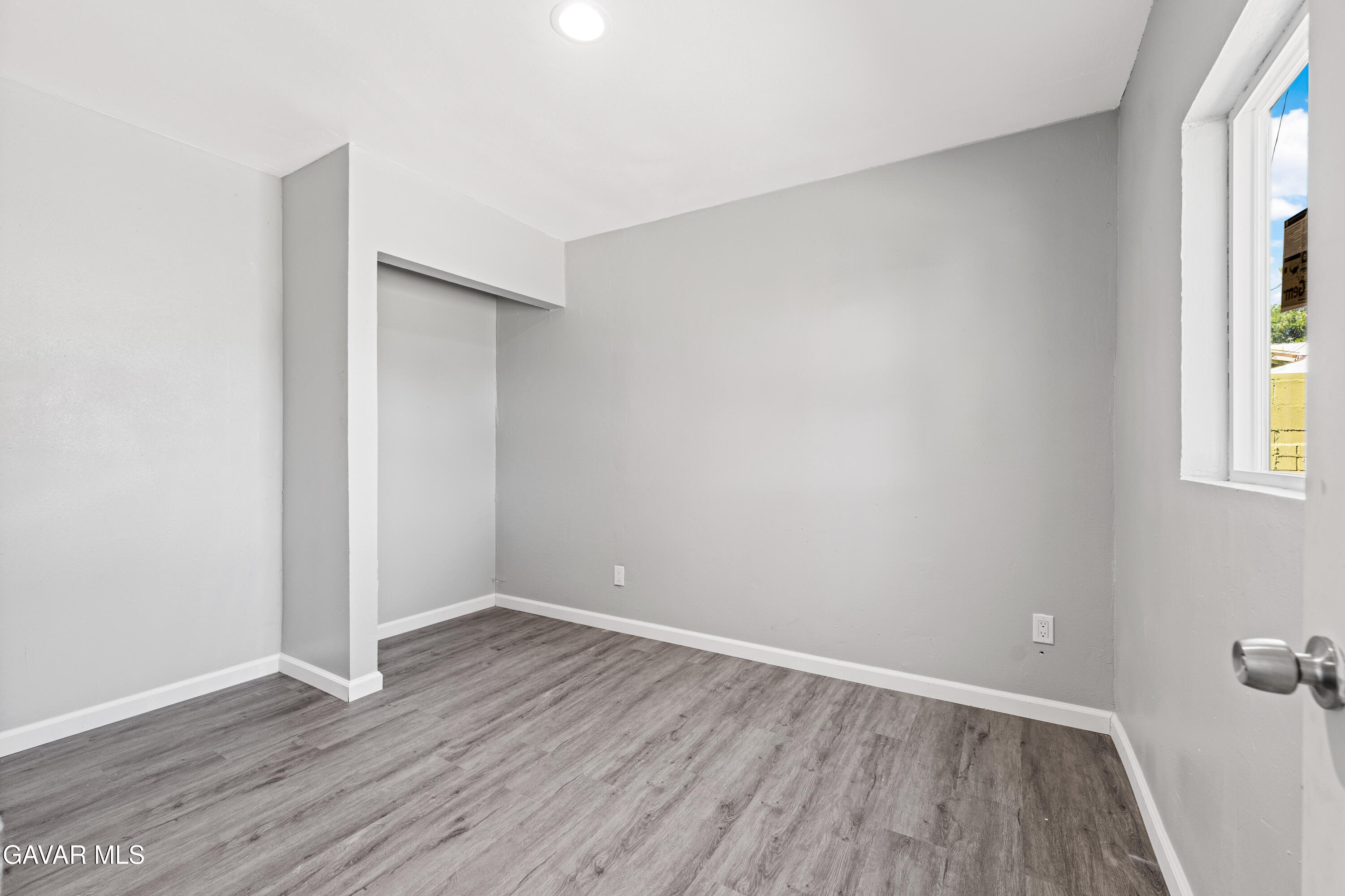 38559 4th Street East Palmdale, CA 93550 - Photo 4 of 5 an empty room with wooden floor and windows