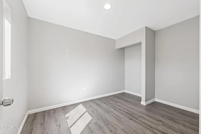 an empty room with wooden floor