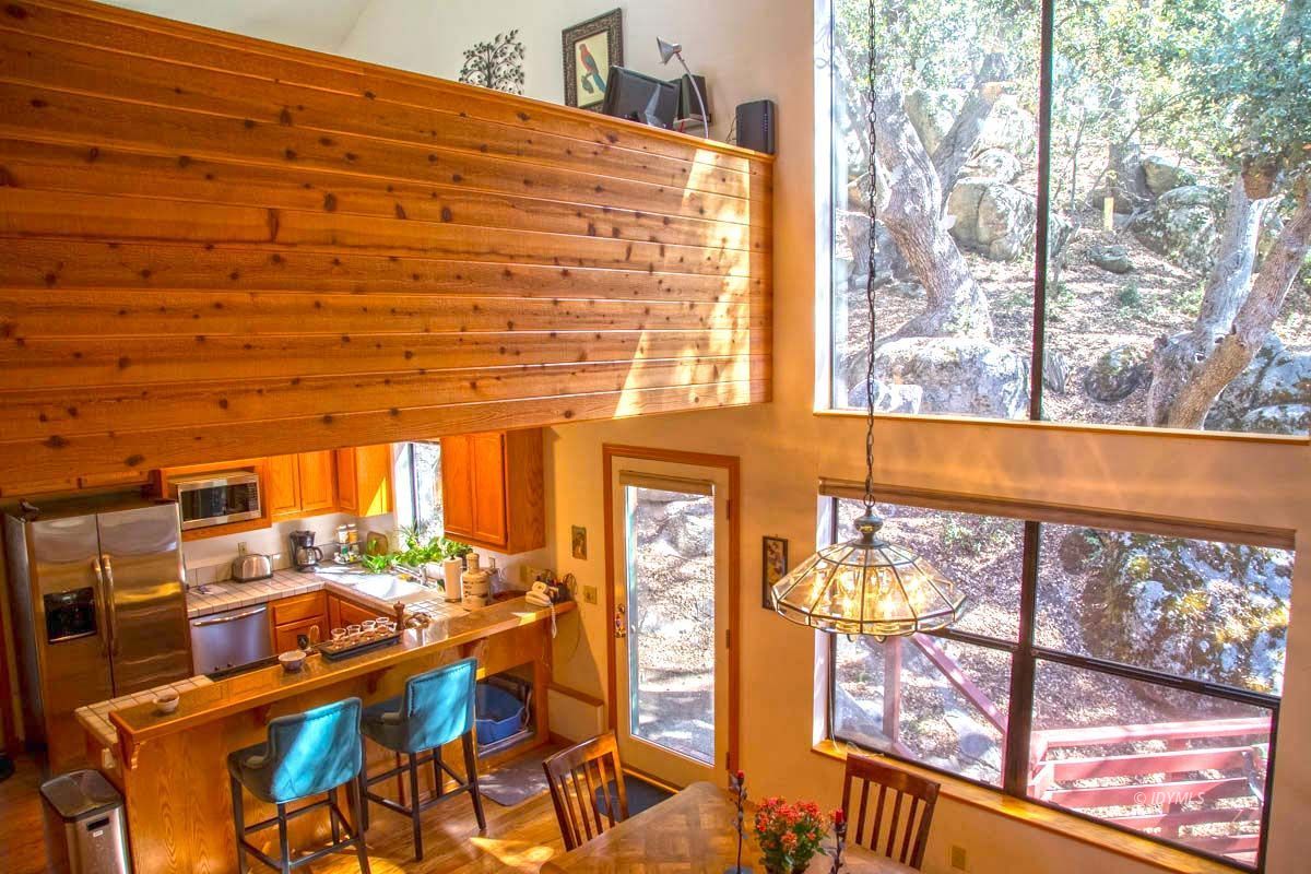 26540 Saunders Meadow Road Idyllwild, CA 92549 - Photo 19 of 34 a view of a living room and kitchen