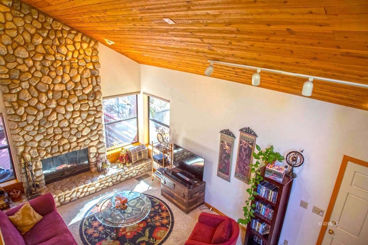26540 Saunders Meadow Road Idyllwild, CA 92549 - Photo 20 of 34 a living room with furniture and a floor to ceiling window