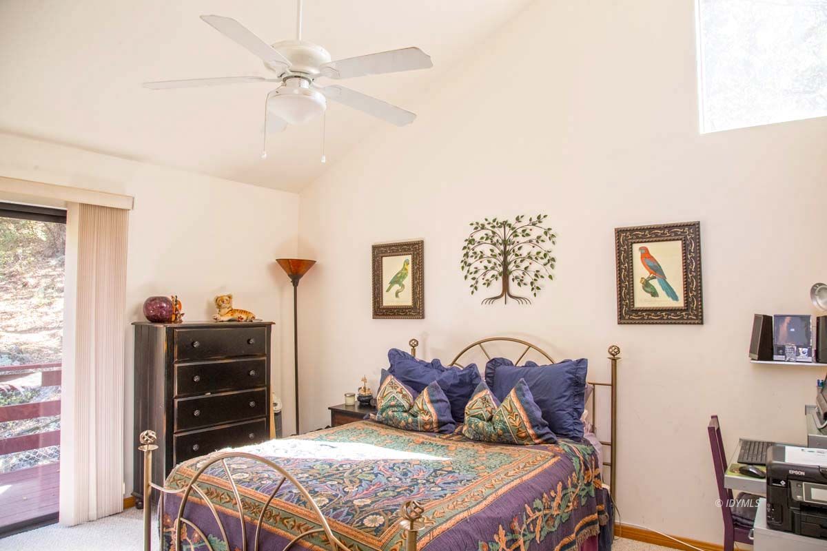 26540 Saunders Meadow Road Idyllwild, CA 92549 - Photo 21 of 34 a bedroom with a bed and a closet with bookshelf