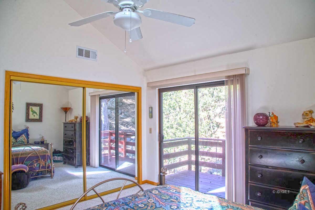 26540 Saunders Meadow Road Idyllwild, CA 92549 - Photo 23 of 34 a bedroom with a bed and a chandelier