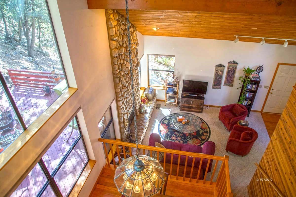 26540 Saunders Meadow Road Idyllwild, CA 92549 - Photo 27 of 34 a living room with furniture and a floor to ceiling window