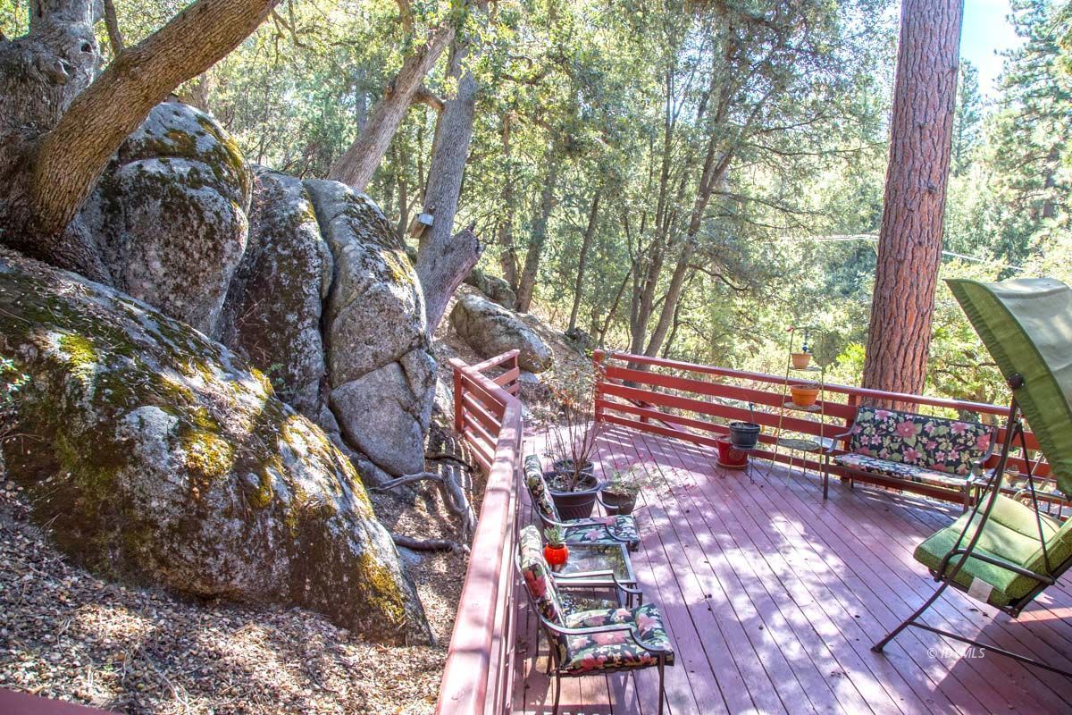 26540 Saunders Meadow Road Idyllwild, CA 92549 - Photo 29 of 34 a view of a yard with plants and a bench