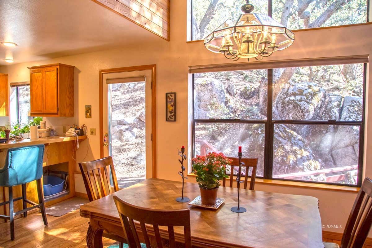 26540 Saunders Meadow Road Idyllwild, CA 92549 - Photo 8 of 34 a dining room with furniture a chandelier and wooden floor