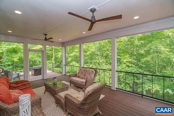 a living room with a window and a potted plant