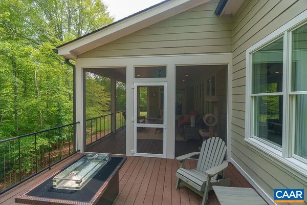 a bathroom with a toilet a sink a tub and mirror