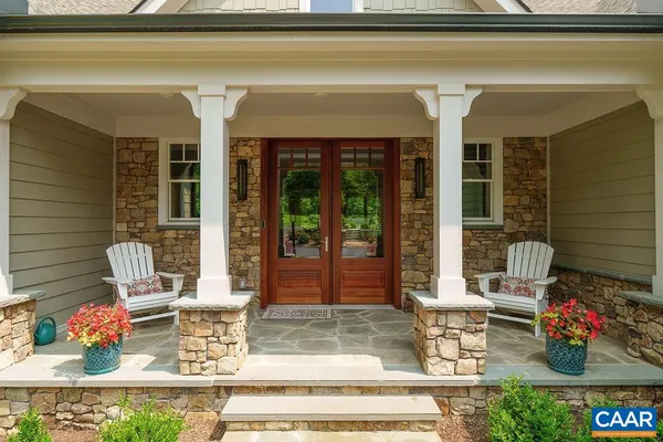 a view of front door with furniture and a window