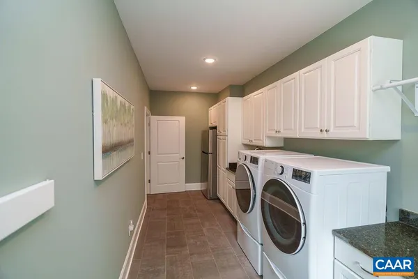 a en suite bathroom with a granite countertop sink a toilet and a mirror