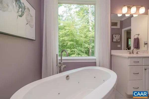 a bathroom with a granite countertop sink a toilet and shower