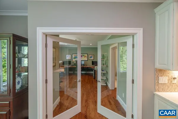 a view of entryway and hall with wooden floor