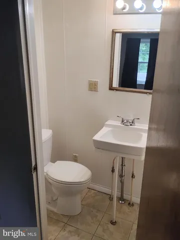 a bathroom with a sink a toilet and mirror