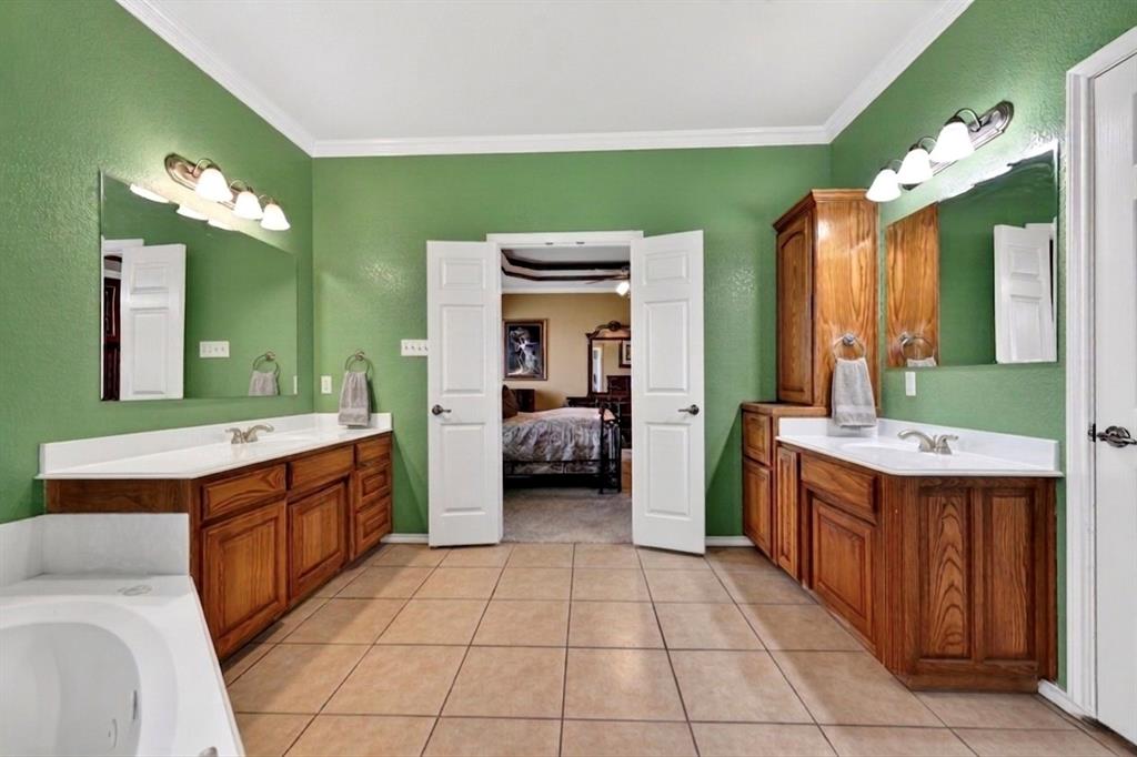 1035 Highland Road Cleburne, TX 76033 - Photo 19 of 36 a large bathroom with a sink and a large mirror