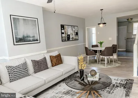 a living room with furniture a rug and a table