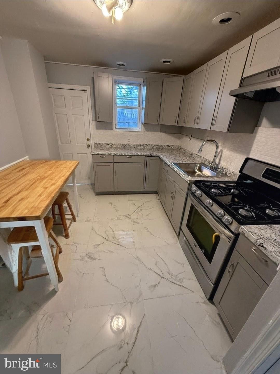 1618 South Bailey Street Philadelphia, PA 19145 - Photo 3 of 8 a kitchen that has a sink and a stove