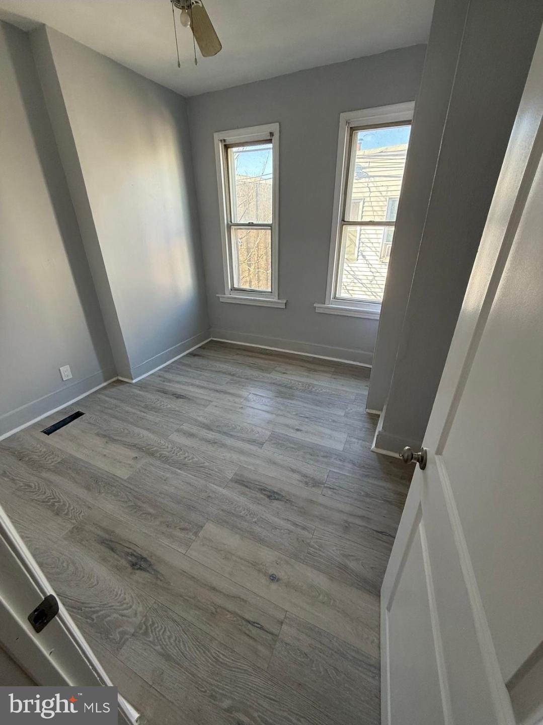 1618 South Bailey Street Philadelphia, PA 19145 - Photo 8 of 8 an empty room with wooden floor and windows