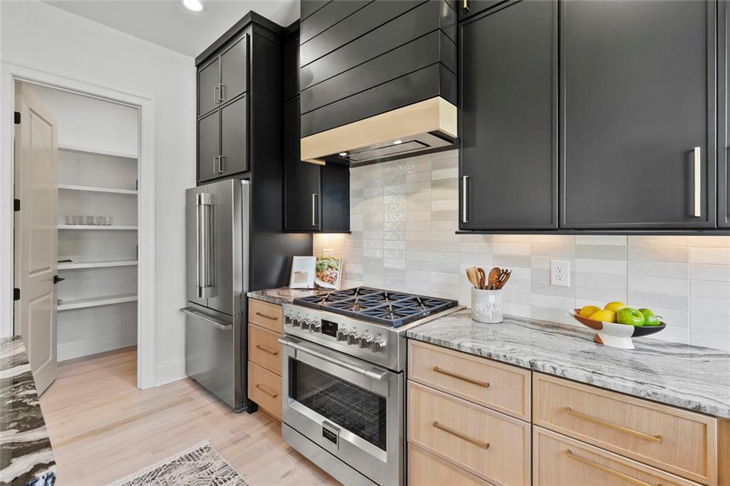 1962 8th Street, Unit 5 Chamblee, GA 30341 - Photo 12 of 57 a kitchen with stainless steel appliances granite countertop a stove and a cabinets