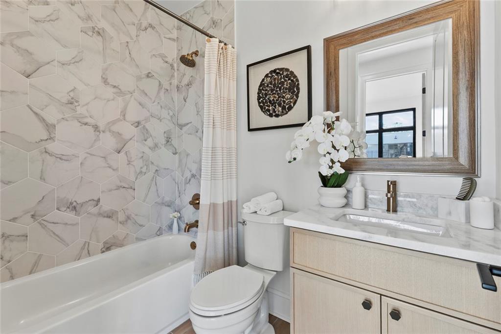 1962 8th Street, Unit 5 Chamblee, GA 30341 - Photo 20 of 57 a bathroom with a sink a toilet and a bathtub