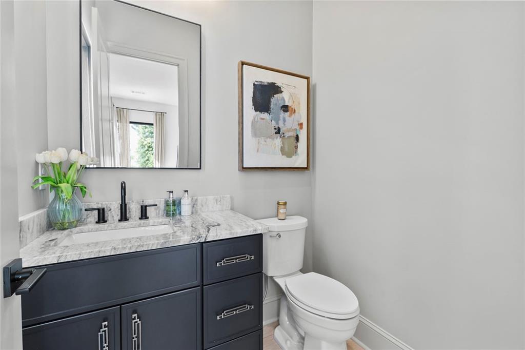 1962 8th Street, Unit 5 Chamblee, GA 30341 - Photo 24 of 57 a bathroom with a toilet sink and mirror