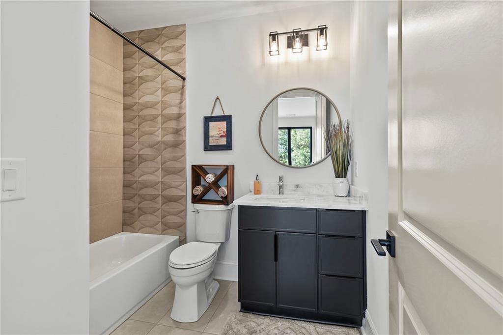1962 8th Street, Unit 5 Chamblee, GA 30341 - Photo 28 of 57 a bathroom with a toilet sink and mirror