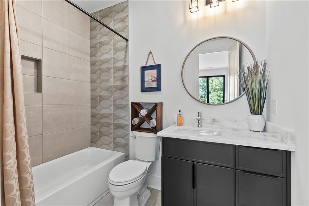 1962 8th Street, Unit 5 Chamblee, GA 30341 - Photo 29 of 57 a bathroom with a toilet a sink and a mirror