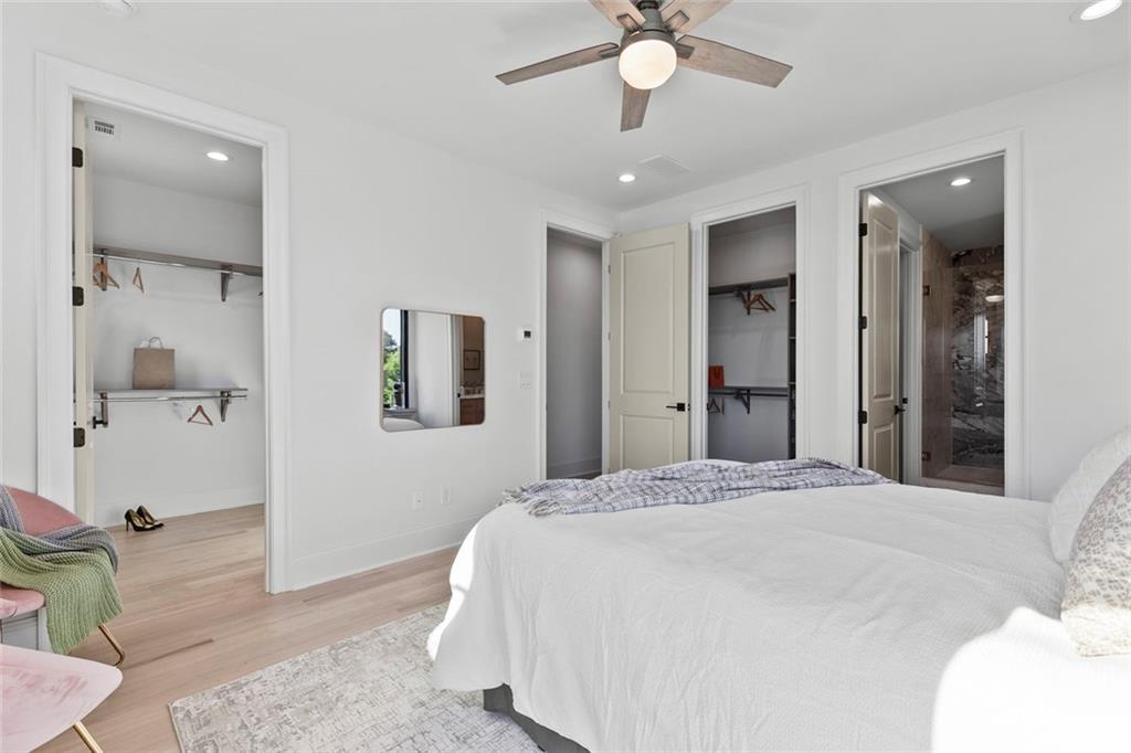 1962 8th Street, Unit 5 Chamblee, GA 30341 - Photo 32 of 57 a spacious bedroom with a bed and a chandelier