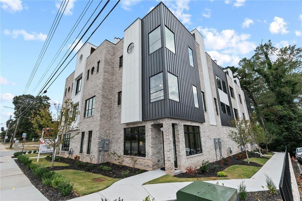 1962 8th Street, Unit 5 Chamblee, GA 30341 - Photo 48 of 57 a front view of a multi story residential apartment building with yard and parking