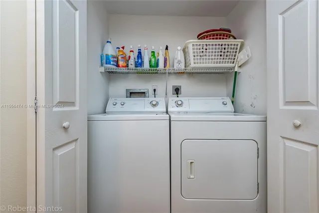 a bedroom with two beds and painting on the wall