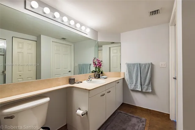 a bathroom with a toilet a sink and shower