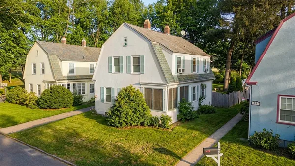 a front view of a house with a yard
