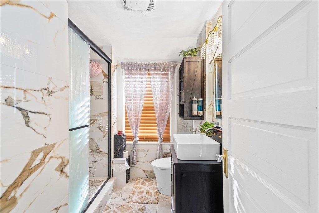 28 Maple Street Southbridge, MA 01550 - Photo 13 of 25 a bathroom with a sink and a mirror