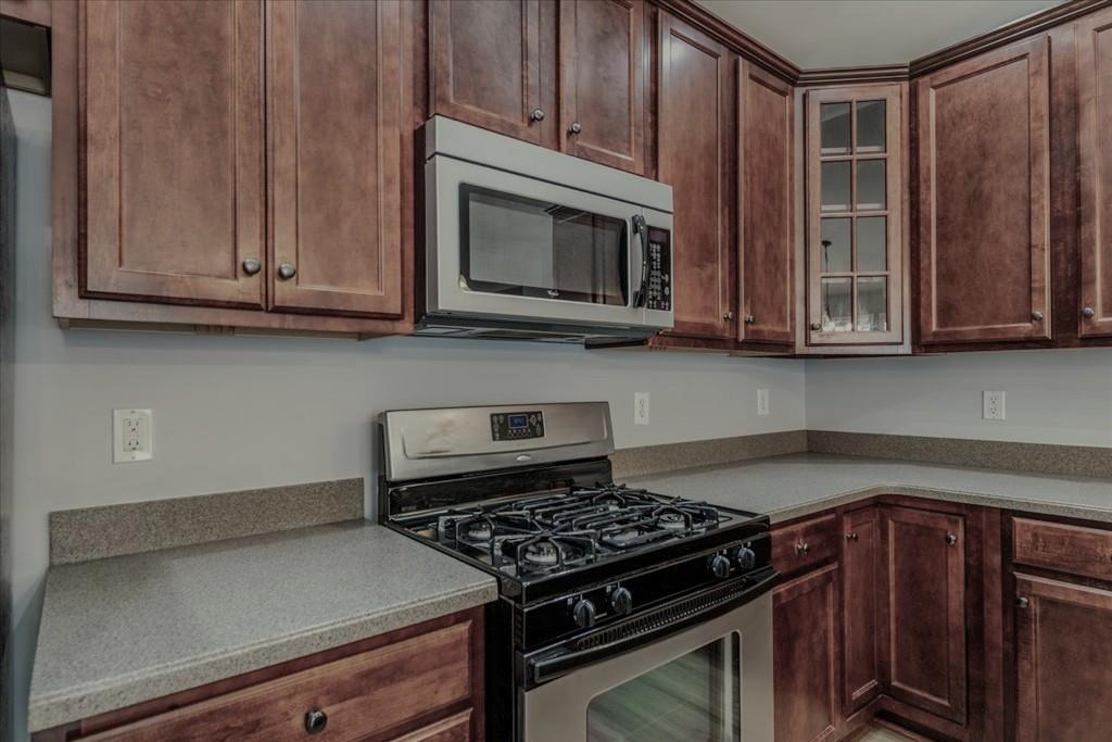 150 Jaime Drive Canton, GA 30114 - Photo 12 of 34 a kitchen with wooden cabinets and a stove top oven