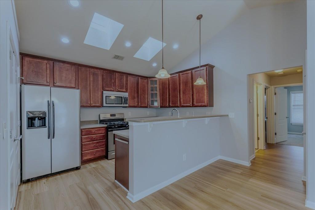 150 Jaime Drive Canton, GA 30114 - Photo 14 of 34 a kitchen with stainless steel appliances granite countertop a refrigerator stove and wooden floor