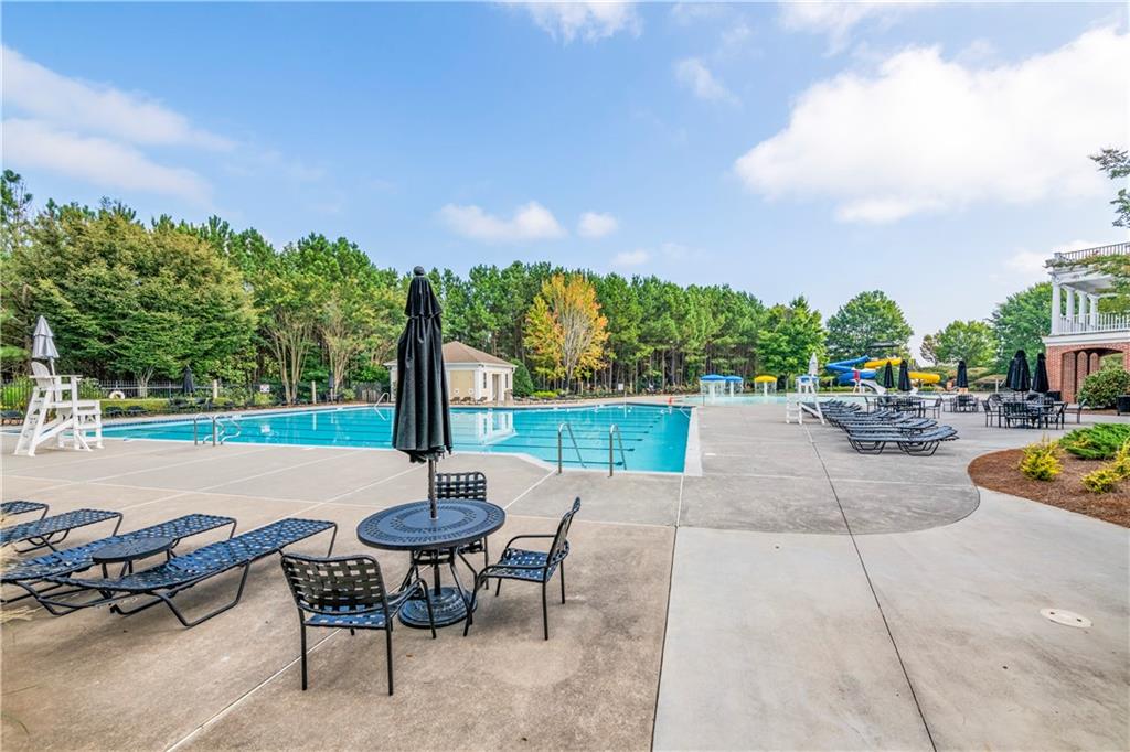 150 Jaime Drive Canton, GA 30114 - Photo 30 of 34 a view of a patio with swimming pool and table and chairs under an umbrella